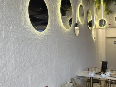 Textured white PHOMI wall finish in a restaurant interior